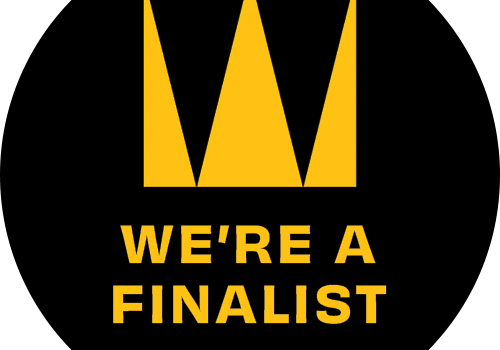 A black circle with a large yellow crown icon above the words WERE A FINALIST and the hashtag #CWAwards26 in yellow text, celebrating The Problem Solver at the Coventry & Warwickshire Chamber Awards.