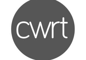 A gray circle with the lowercase letters cwrt in white centered inside, subtly reflecting the cohesive design philosophy of Glued Limited.