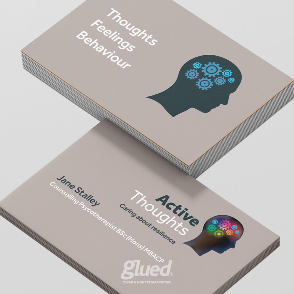 Glued Limited creative work: A stack of business cards for a counselling psychotherapist, featuring a human head with gears, and text reading “Thoughts, Feelings, Behaviour” and “Active Thoughts, Caring about resilience – Jane Stalley, Counselling Psychotherapist.”.