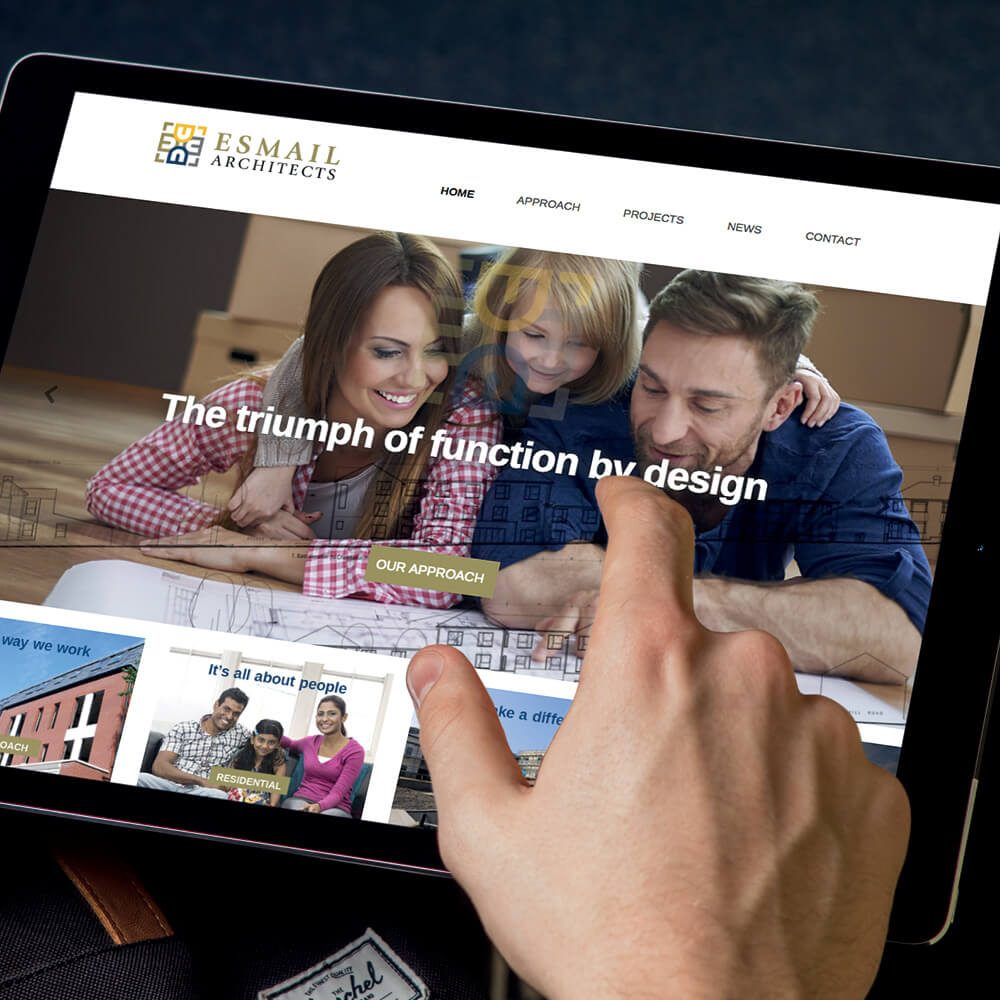 Glued Limited creative work: A hand touches a tablet screen displaying a WordPress website design and build at affordable prices for Esmail Architects, featuring a smiling family and the text The triumph of function by design, with navigation options and project images visible.