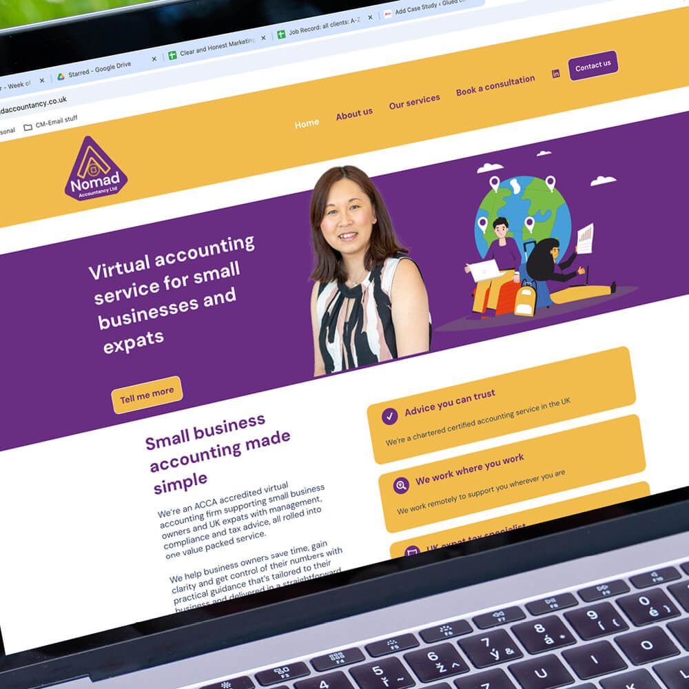 Glued Limited creative work: A laptop screen displays the Nomad virtual accounting website, designed with purple and yellow branding, featuring a smiling woman, navigation menu, and text offering affordable Wordpress website design and build alongside accountancy services for small businesses and expats.